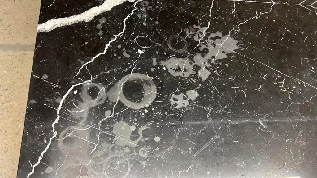 Stains and etching on black marble countertops