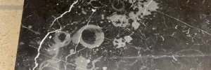 Stains and etching on black marble countertops